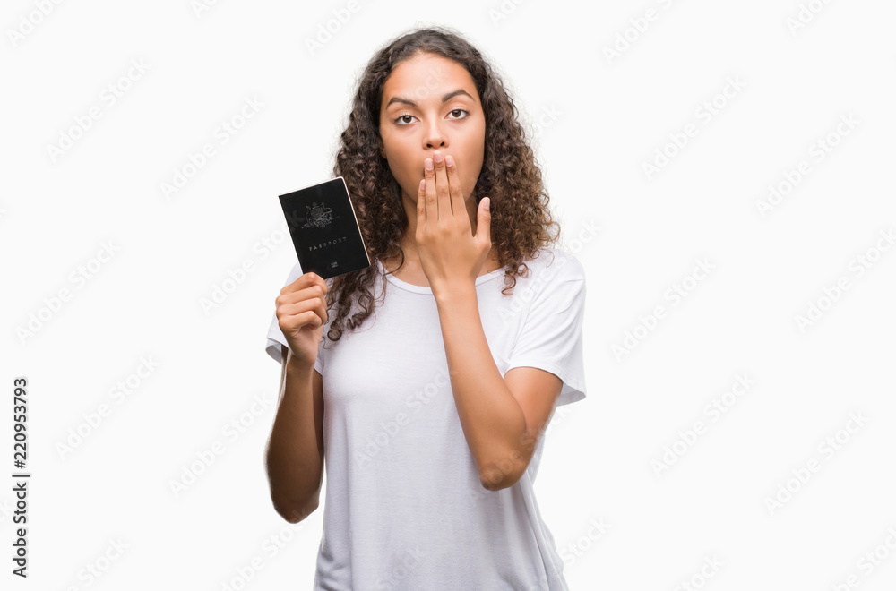 Young hispanic woman holding passport of Australia cover mouth with hand shocked with shame for mistake, expression of fear, scared in silence, secret concept Young hispanic woman holding passport of Australia cover mouth with hand shocked with shame for mistake, expression of fear, scared in silence, secret concept