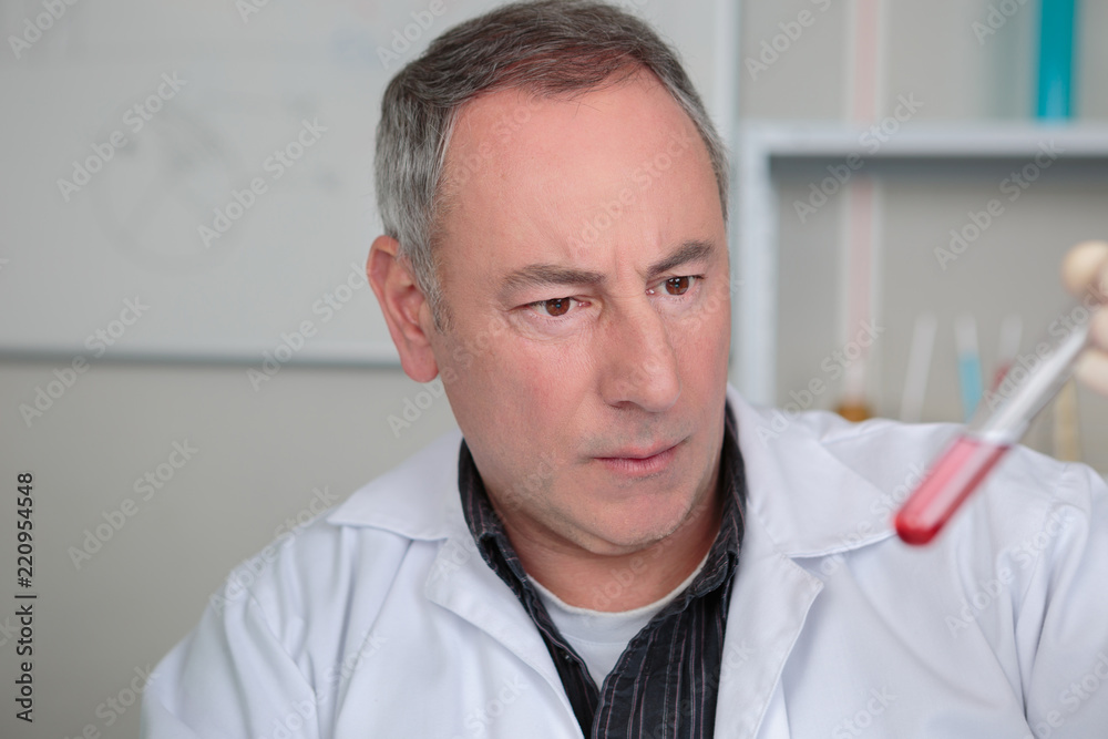 Concerned man looking at vial