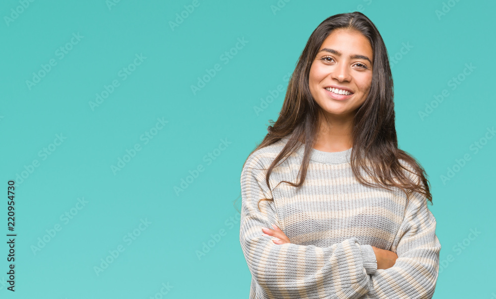 Young beautiful arab woman wearing winter sweater over isolated background happy face smiling with crossed arms looking at the camera. Positive person. Young beautiful arab woman wearing winter sweater over isolated background happy face smiling with crossed arms looking at the camera. Positive person.