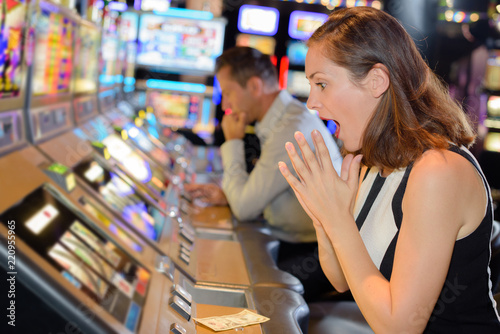 woman celebrating win on slot machine at casino
