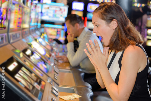 фотографія woman celebrating win on slot machine at casino