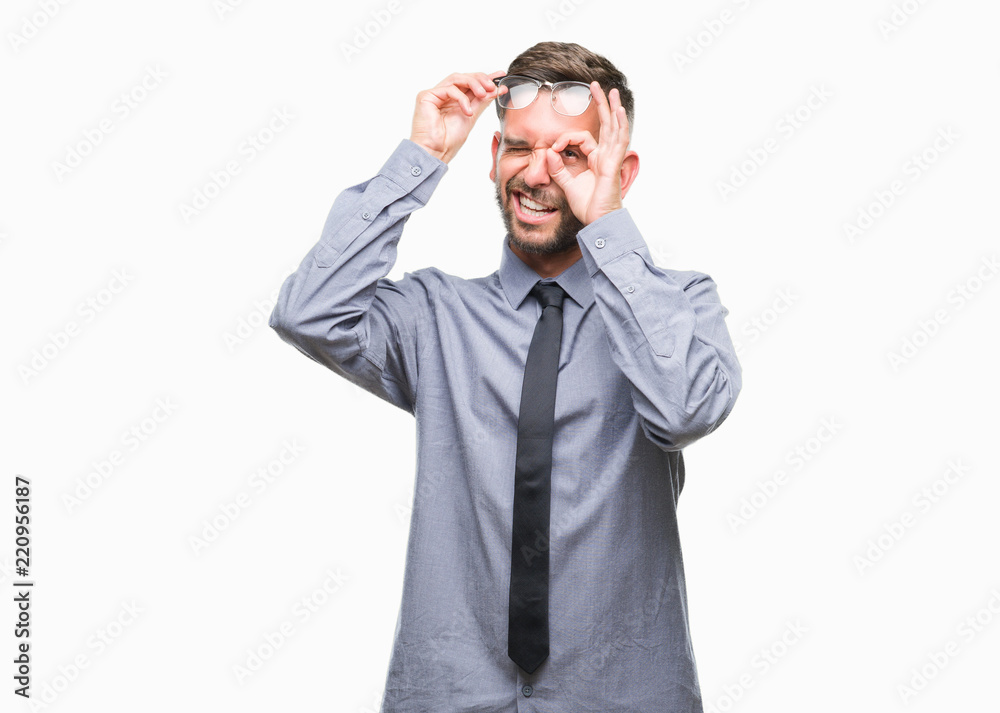 Young handsome business man over isolated background doing ok gesture with hand smiling, eye looking through fingers with happy face. Young handsome business man over isolated background doing ok gesture with hand smiling, eye looking through fingers with happy face.