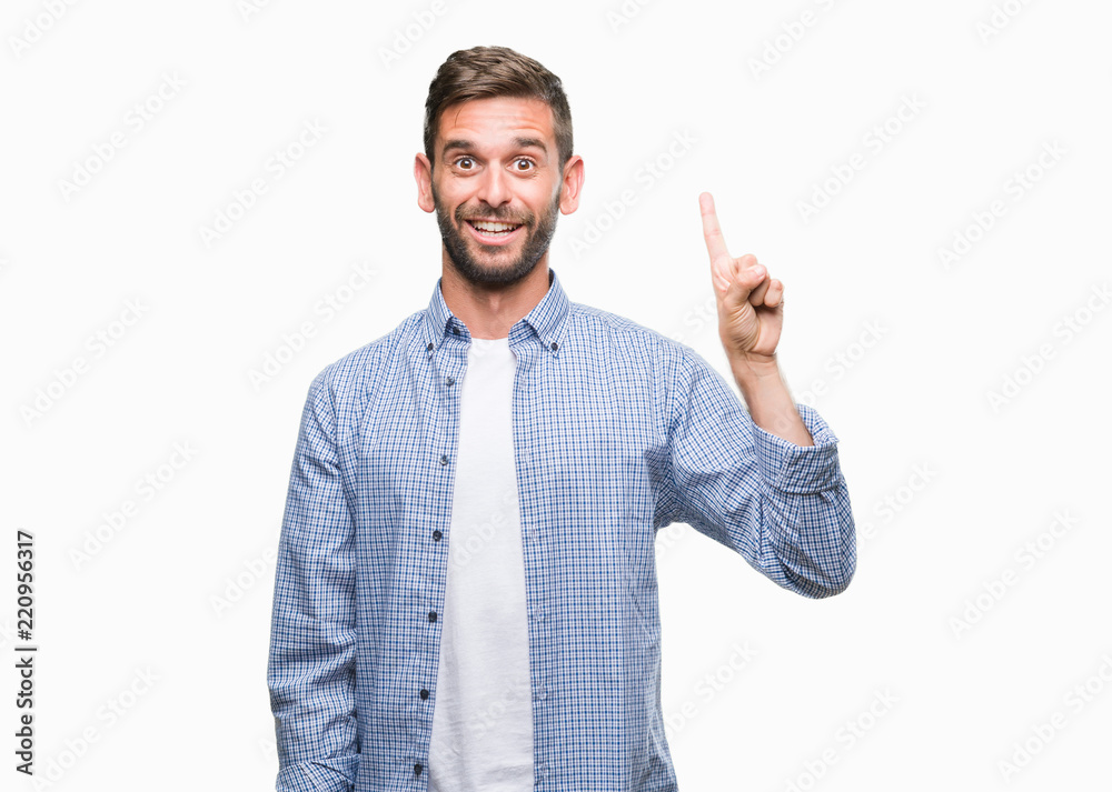 Young handsome man wearing white t-shirt over isolated background showing and pointing up with finger number one while smiling confident and happy. Young handsome man wearing white t-shirt over isolated background showing and pointing up with finger number one while smiling confident and happy.
