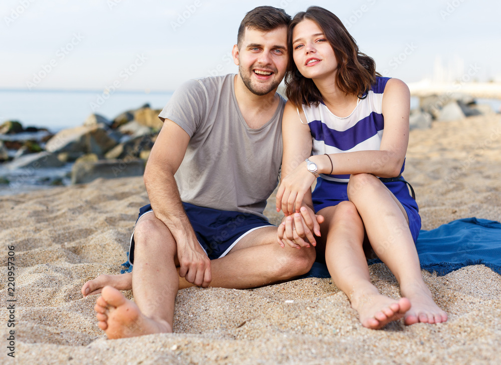 Fototapeta premium Happy loving couple sitting and hugging