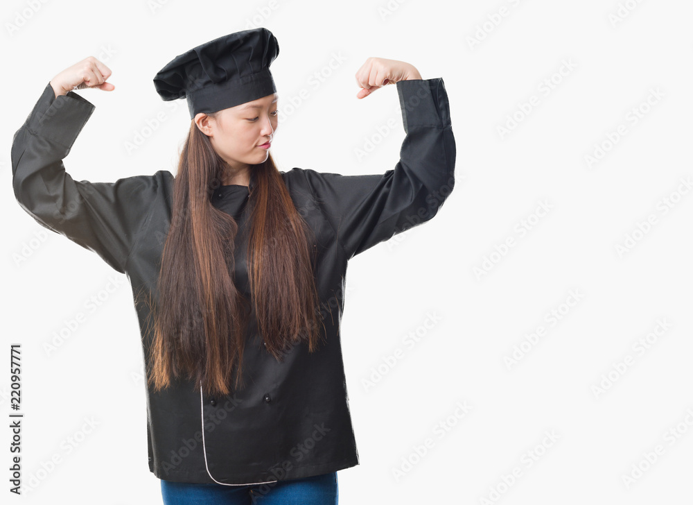 Young Chinese woman over isolated background wearing chef uniform showing arms muscles smiling proud. Fitness concept. Young Chinese woman over isolated background wearing chef uniform showing arms muscles smiling proud. Fitness concept.