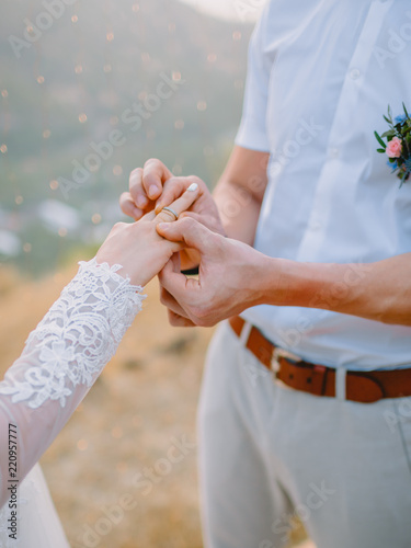Bride and bridegroom holds a wedding ring. Wedding ceremony