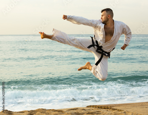 Adult man practising karate kata poses