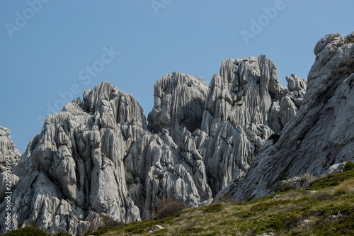 Small karst features  small-scale landforms  as grikes  runnels and solution flutes are formed from the dissolution of soluble rocks such as limestone and dolomite. 