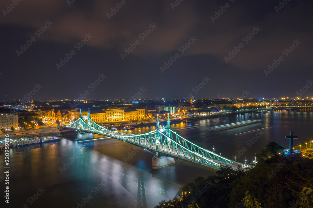 Scenic night scape of Budapest. Danube river and Freedom bridge in backlight