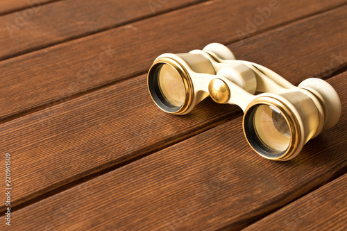 Vintage theatre binoculars on an old wooden table