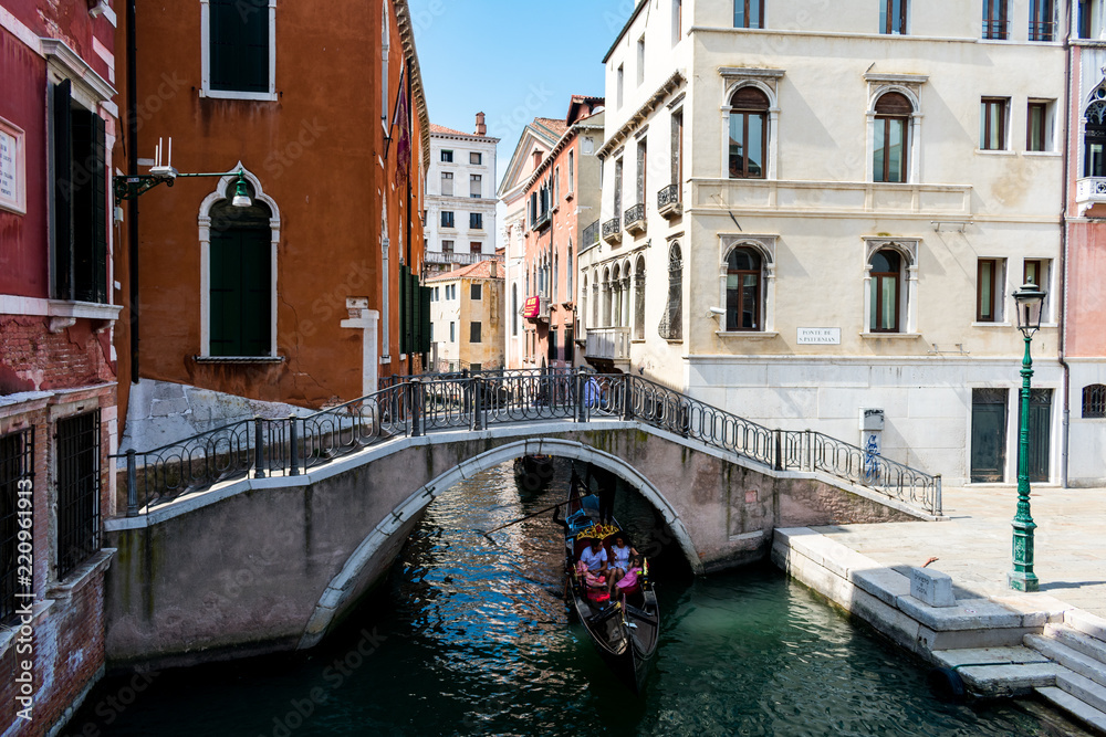 A bridge with a gondola underneath in Venice, Italy