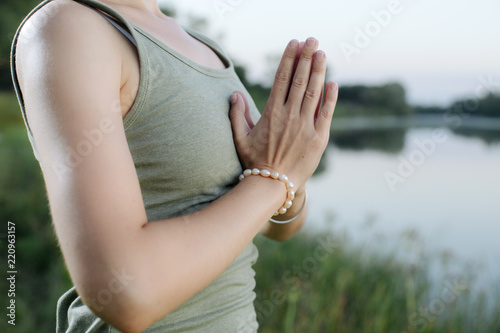 mudra of hand  young woman are folded in a special way into a yoga. Behind a strongly blurred background photo