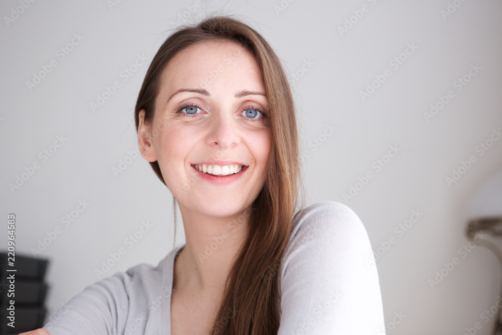 Close up happy young woman smiling and staring at camera Close up happy young woman smiling and staring at camera