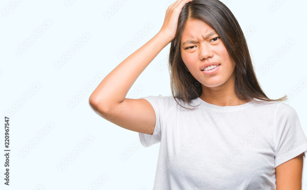 Young asian woman over isolated background suffering from headache desperate and stressed because pain and migraine. Hands on head. Young asian woman over isolated background suffering from headache desperate and stressed because pain and migraine. Hands on head.