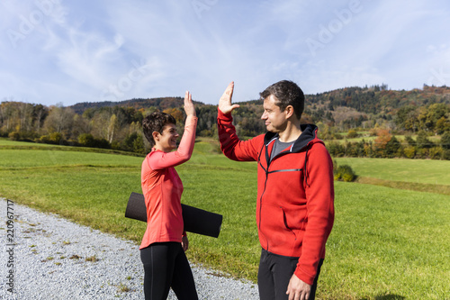 A couple set ready for outdoor exercises on a sunny autumn day in the countryside of Bavarian National Forest Park photo