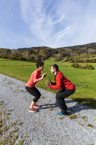 A couple is set ready for outdoor exercises on a sunny autumn day in the countryside of Bavarian National Forest Park