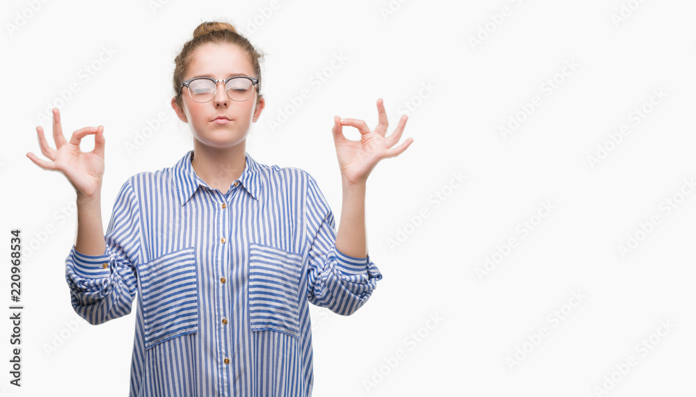 Young blonde business woman relax and smiling with eyes closed doing meditation gesture with fingers. Yoga concept. Young blonde business woman relax and smiling with eyes closed doing meditation gesture with fingers. Yoga concept.
