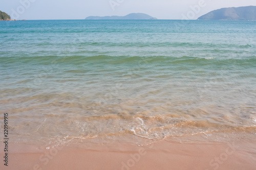 Sea water, wave, mountains and sand