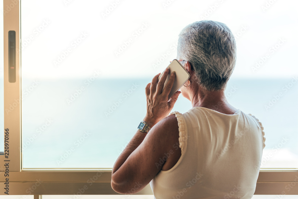 Elderly woman on the mobile phone at home Elderly woman on the mobile phone at home