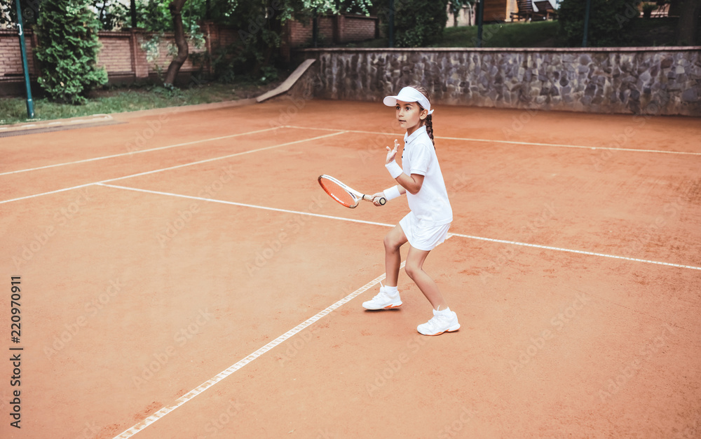 Young and beautiful tennis player in action on the court.