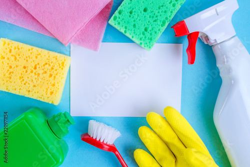 Different supplies for cleaning houses on a blue background. Cleaning concept. Top view, copy space