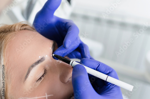 Doctor doing preparations for botox procedure on woman