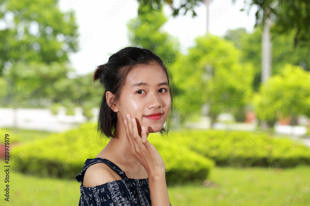 the face of young woman in bright background the face of young woman in bright background