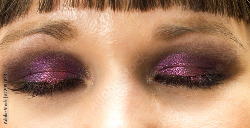 eyes makeup closeup with purple eyeshadow