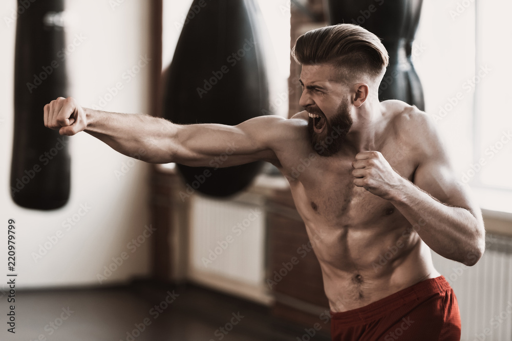 Athletic Male Boxer Training at Boxing studio