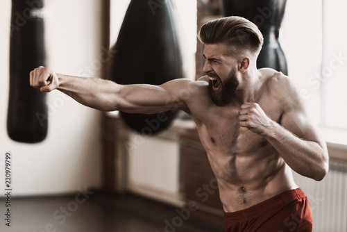 Athletic Male Boxer Training at Boxing studio © VadimGuzhva