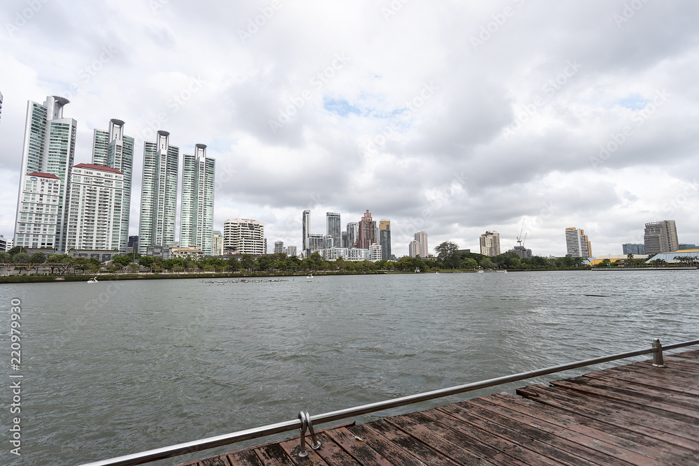 Bangkok, Thailand - August 18, 2018 : Lake Ratchada situated in the Benjakitti Park with modern buildings in the background in midtown Bangkok, Thailand.