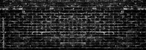 Grunge style background of wide black and white aged brick wall