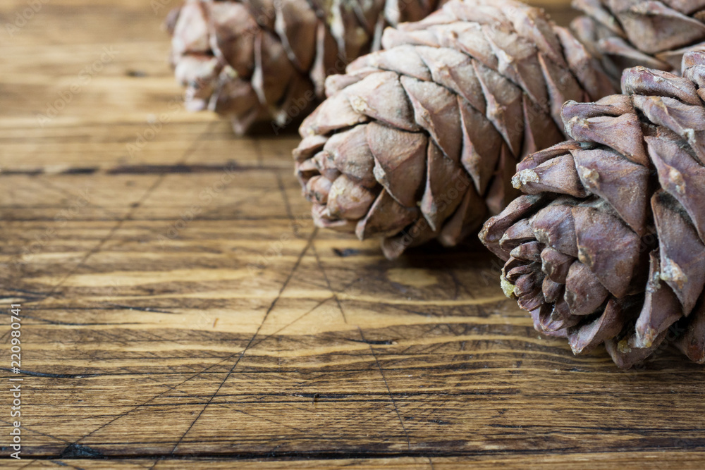 Pine cones on rustic wooden background. Autumn concert. Selective focus Pine cones on rustic wooden background. Autumn concert. Selective focus