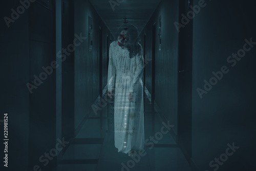 Scary female ghost walks in the hotel corridor