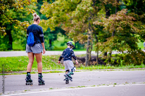 Mom and son roller skating in the Park