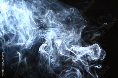 lovely flowing glowing bright smoke on heavy black background.