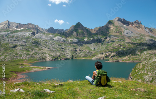 woman hiker looking at Lake Estaens in the Pyrenees mountains
