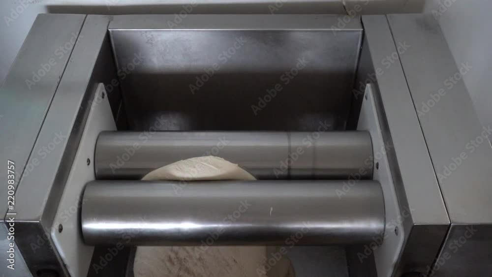 in an artisan bakery, the baker kneads the dough for the bread. in an artisan bakery, the baker kneads the dough for the bread.