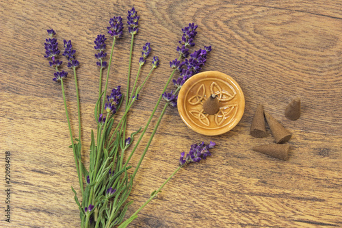 Fototapeta Naklejka Na Ścianę i Meble -  Cones incense and lavender flowers on a wooden table - aromatherapy theme background