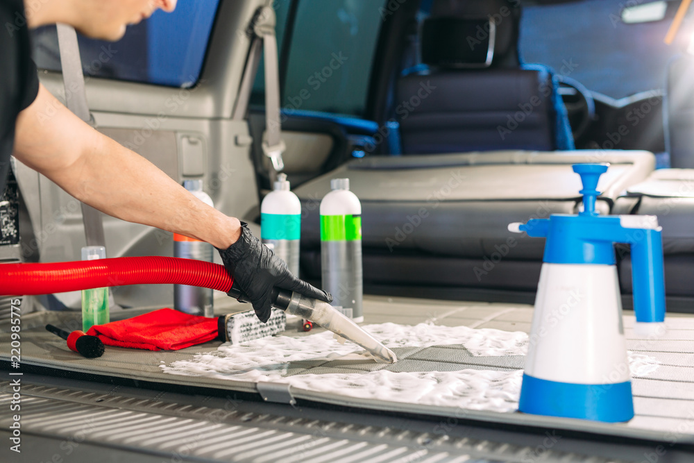 Fototapeta premium Car chemist. Chemical treatment of the car trunk.