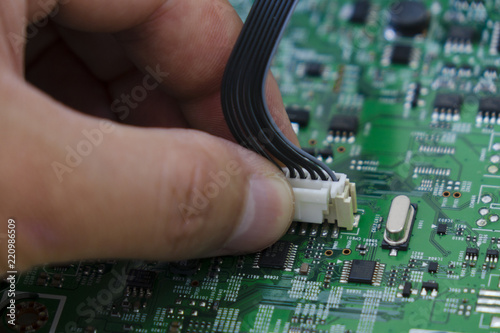 Quality control and assembly of SMT printed components on circuit board in QC lab of PCB manufacturing high-tech factory photo