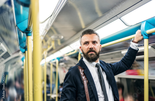 Photography Hipster businessman inside the subway in the city, travelling to work
