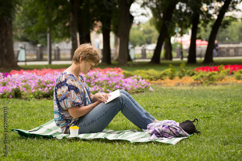 Peaceful woman sitting and reading a book © lanara@bk.ru