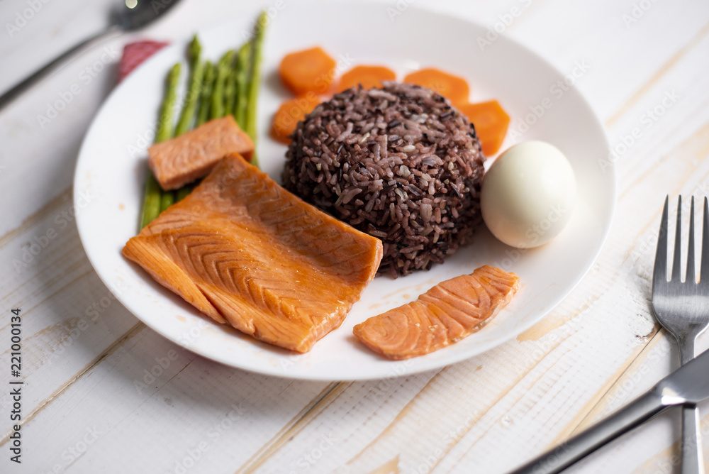 Health food concept, salmon with rice and vegetable on wood background Health food concept, salmon with rice and vegetable on wood background