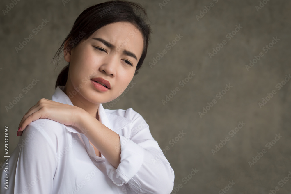 woman with shoulder or neck pain; portrait of asian woman suffering from shoulder or neck pain, stiffness, injury, chronic bone or muscle injury concept; asian young adult woman health care model woman with shoulder or neck pain; portrait of asian woman suffering from shoulder or neck pain, stiffness, injury, chronic bone or muscle injury concept; asian young adult woman health care model
