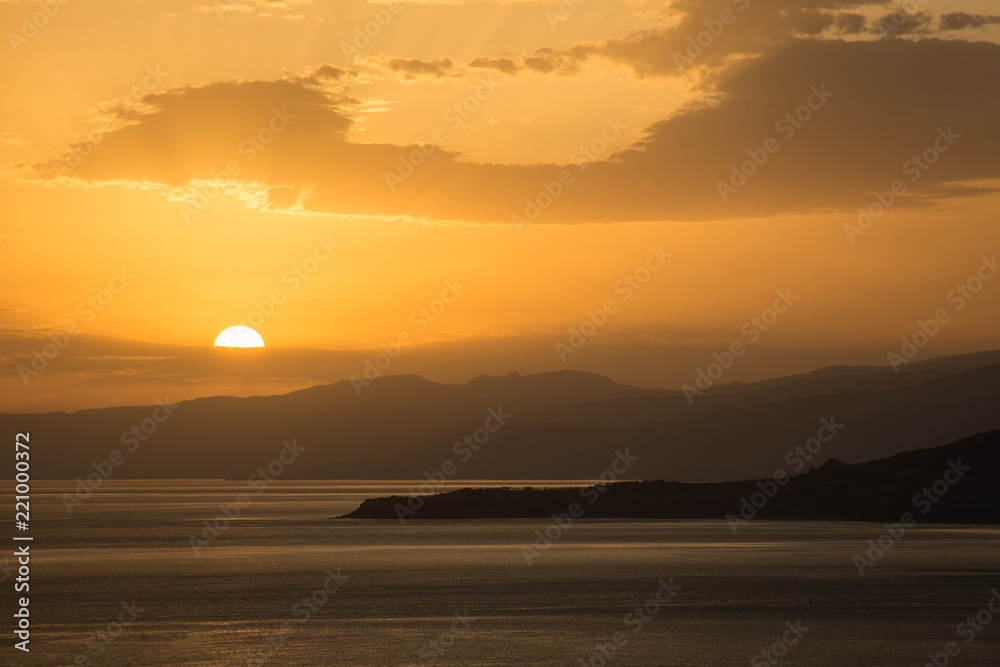 A sunrise over the Mediterranean sea and some mountains in Sicily 
