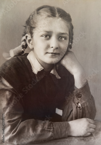 Obraz na płótnie Antigue Photo of school girl in school form sitting.1940-s. USSR. Soviet girl. w salonie