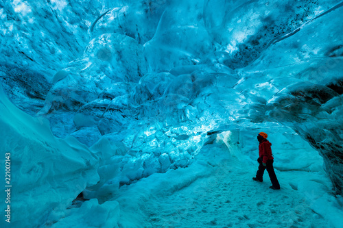 explorer inside an ice cave, vatnajokull national park, Iceland photo