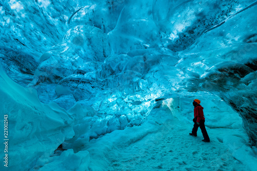 explorer inside an ice cave, vatnajokull national park, Iceland