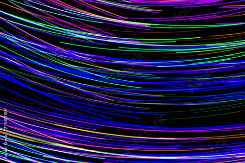 Multi color light painting, long exposure photography, abstract lines of color against a black background